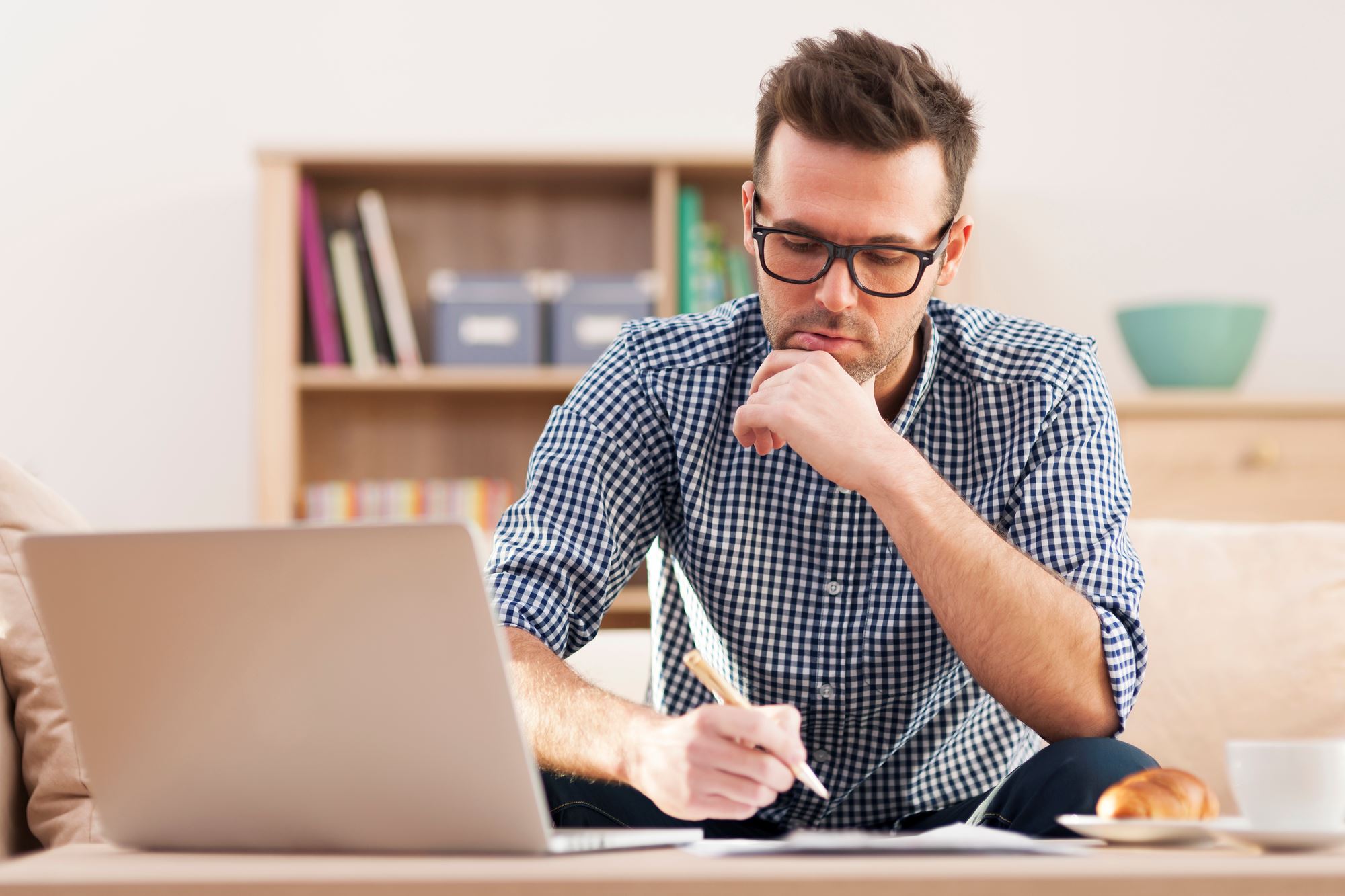 Man thinking of effective meta descriptions at his computer